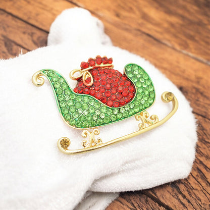 Christmas brooch sleigh rhinestones / gold colored / 30x45mm