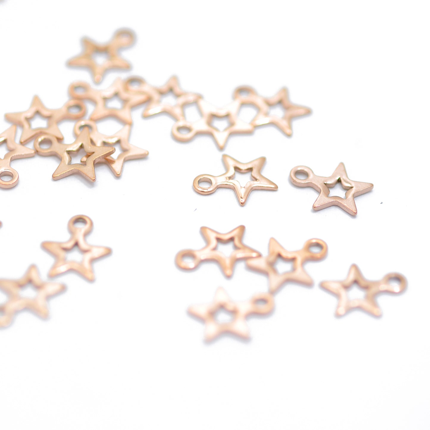 Stainless steel mini star pendant / rose gold plated / 7mm