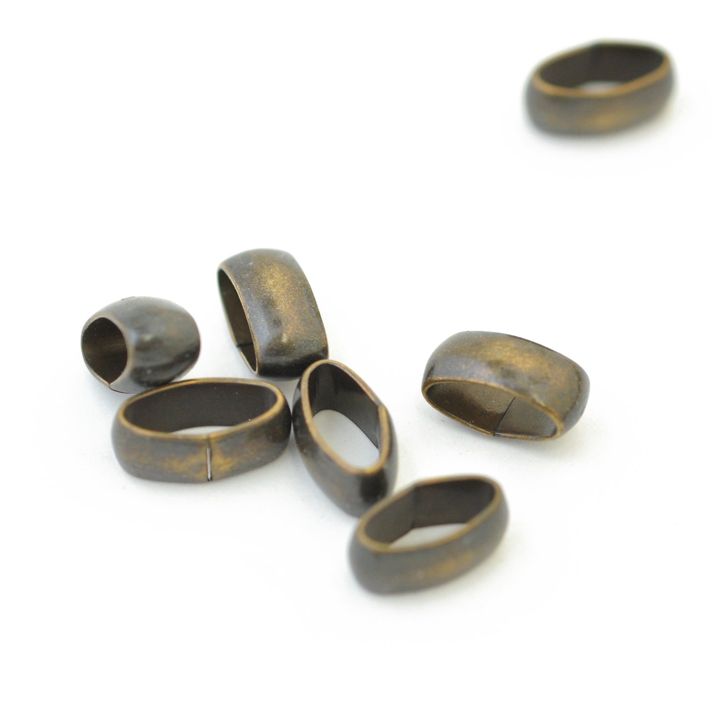 Oval metal spacer / brass colored / 12 mm